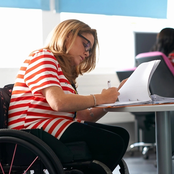 College girl in a wheelchair studying