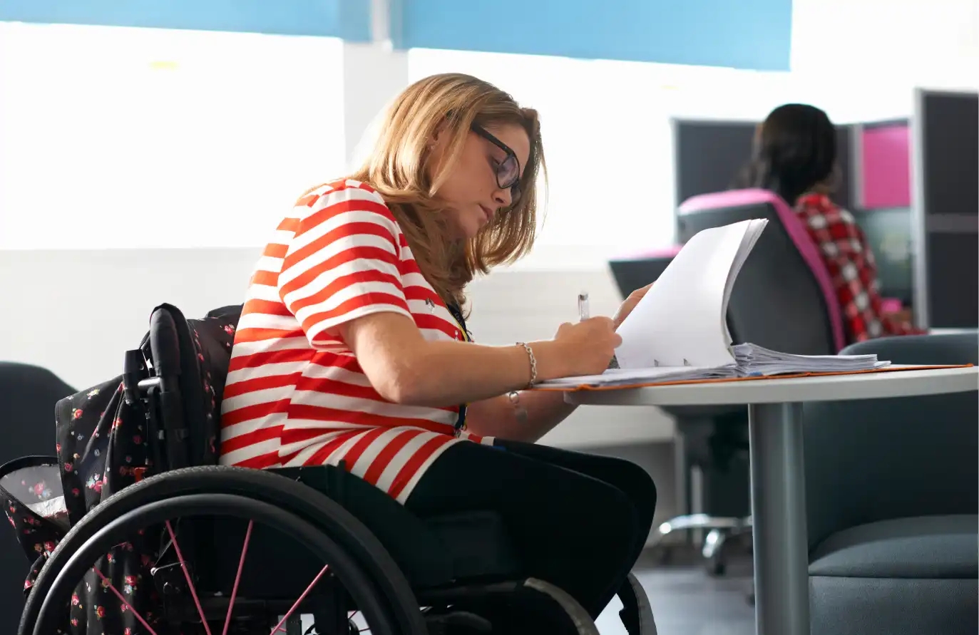 College girl in a wheelchair studying