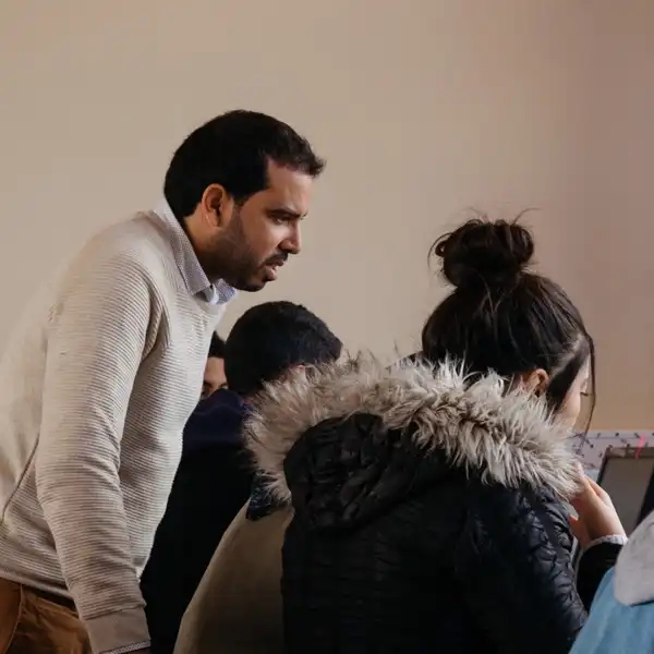 Teacher looking over the work of students