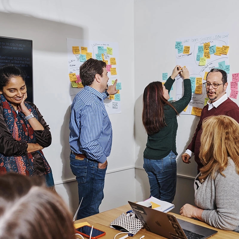 Coworkers brainstorm together in conference room